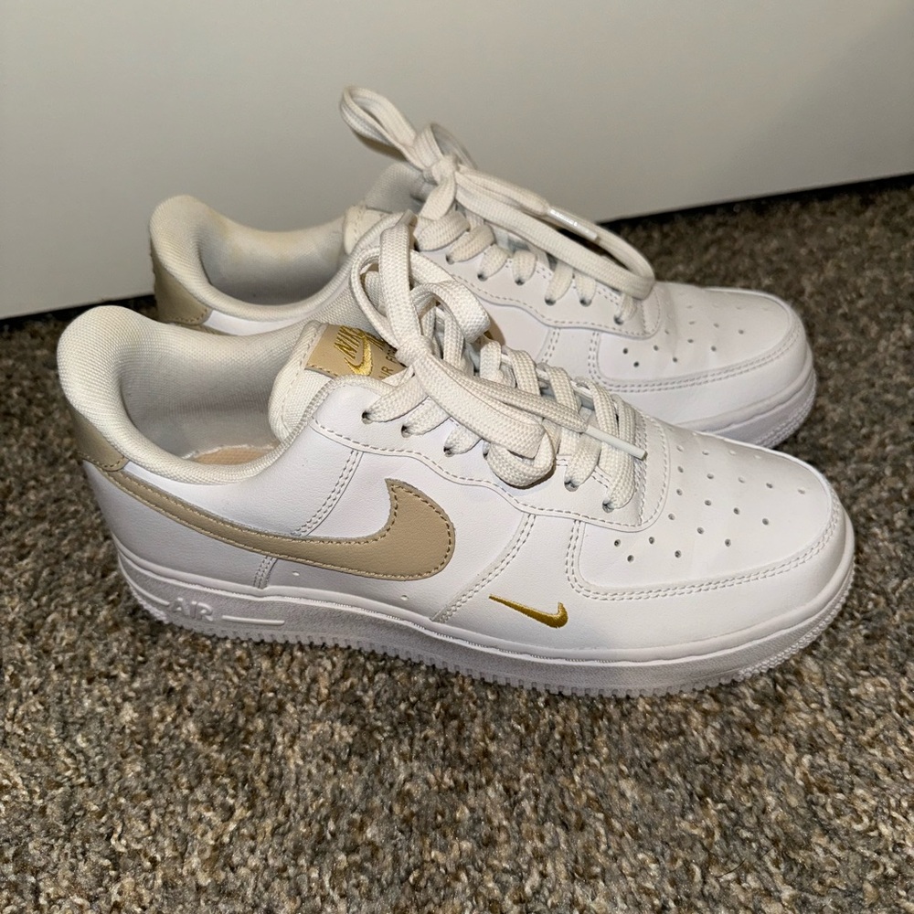 Nike Classic White Sneakers with Gold Highlights